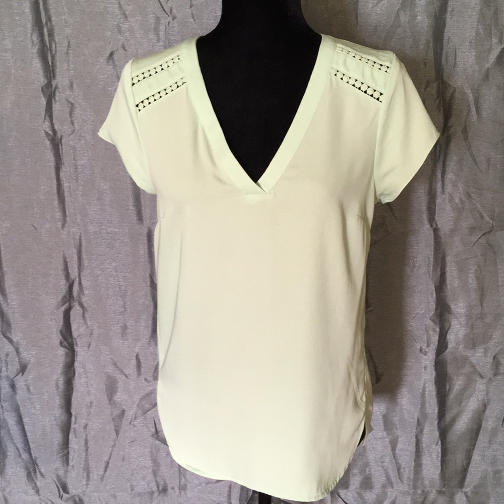 Mint colored polyester blouse.